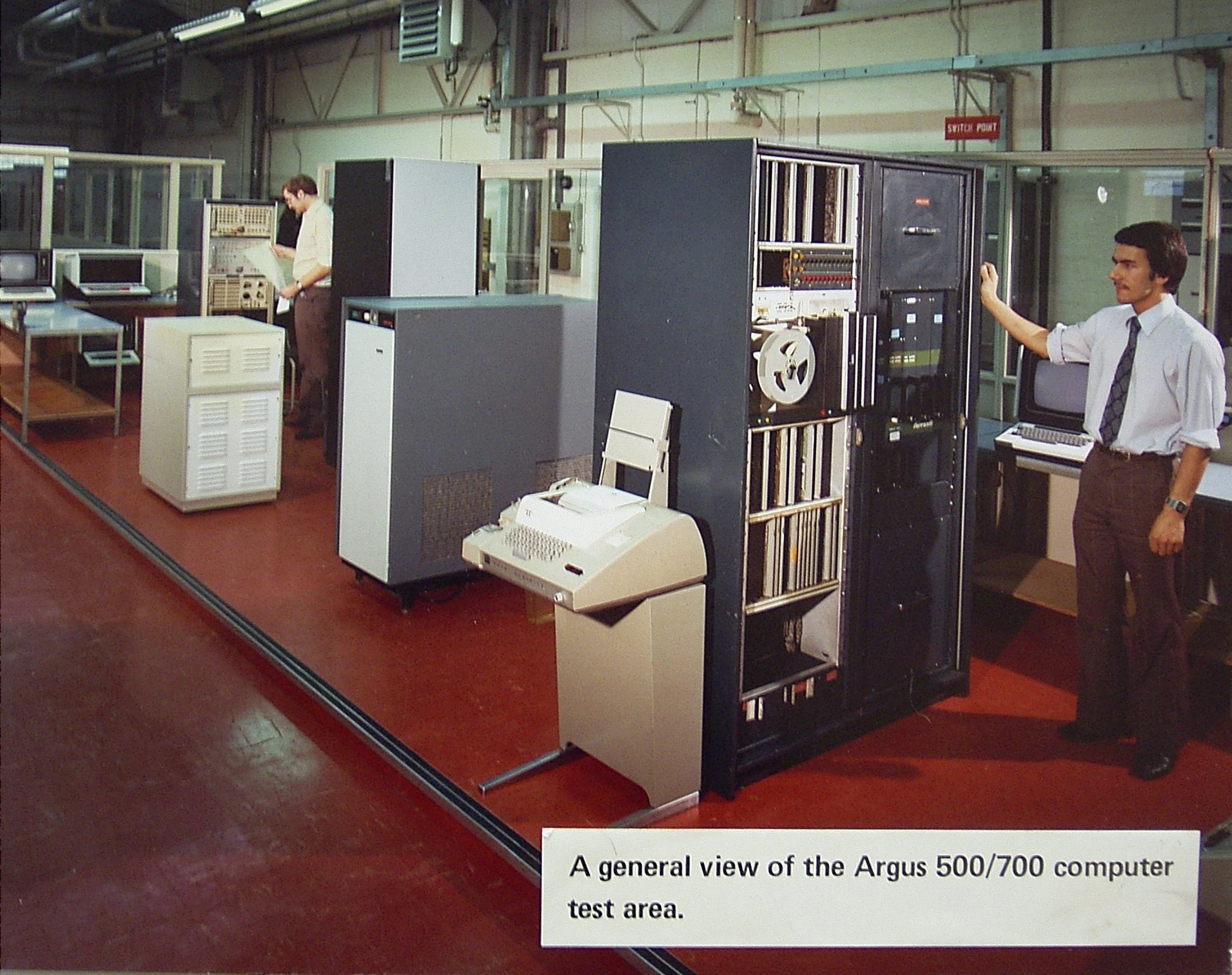 A person at the console of a Ferranti Argus 500 computer system.